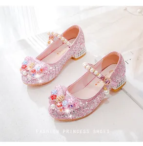 Detailed view of pink glitter princess shoes with 3D floral accents and pearl straps