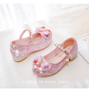 Macro shot of pink glitter girls princess shoes with floral pearls and rhinestone detail
