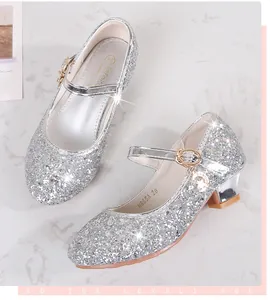 Macro detail of sparkly silver sequin Mary Jane shoes with moon pendant for girls