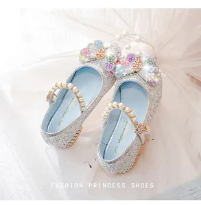 Detail of glitter princess shoes featuring colorful 3D flowers and pearl strap