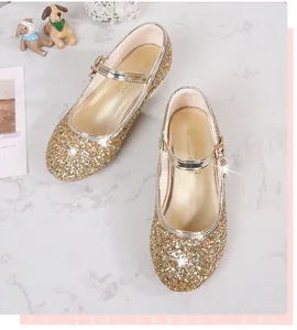 Detailed top view of gold sequin Mary Jane shoes for girls on a marble background