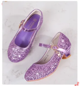 Close-up of purple sequin Mary Jane shoes with golden moon and star charms for girls