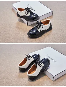 Détail de chaussures Richelieu noir et blanc pour garçons avec perforations décoratives