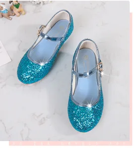 Detail shot of sparkling lake blue sequin Mary Jane shoes with metal buckle and gold pendant