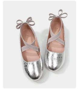 Detail of silver crackle texture princess shoes with elastic straps and heel bow