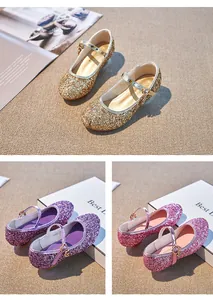 Close-up of glitter Mary Jane shoes for girls featuring sparkly sequins and heart charms