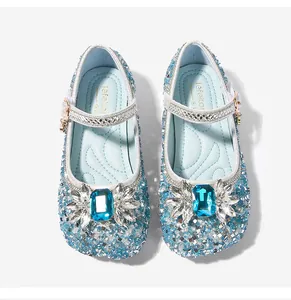 Top view of blue princess shoes with sparkling sequins and a large rectangular gemstone