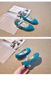 Close-up of blue sequin Mary Jane shoes for girls featuring a heart charm and silver heel