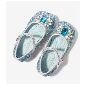Close-up of girls blue sequin Mary Jane shoes with rectangular rhinestone buckle detail