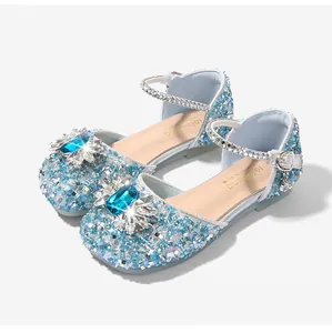 Macro view of blue glitter girl sandals with large gemstone and rhinestone detailing