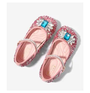 Close-up of pink glitter Mary Jane shoes with blue rhinestone floral crystals for girls