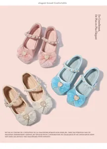 Detailed close-up of girls' glitter Mary Jane shoes with mesh bows and pearl straps