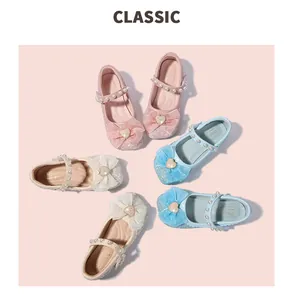 Detail of glitter Mary Jane shoes for girls featuring tulle bows and pearl straps