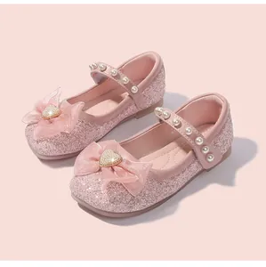 Close-up of pink sequin Mary Jane shoes with mesh bow and pearl heart detail