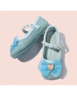 Detail of blue sequin Mary Jane shoes with mesh bow and heart-shaped rhinestone