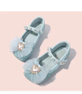 Dettaglio di scarpe Mary Jane blu glitterate con tessuto di paillettes e fiocco in mesh