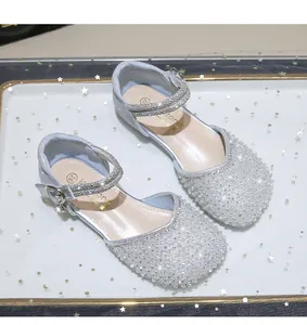 Detail of silver sparkling girls Mary Jane shoes with glitter crystals and buckle strap