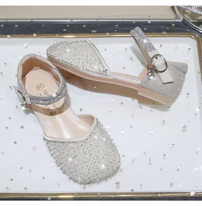 Close-up of pearl and rhinestone details on silver girls' princess flat shoes