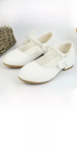 Detail of white girls' princess shoes featuring elegant pearl beads and bowknot strap