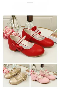 Detail view of Mary Jane shoes in red, gold, and pink with pearl and bow accents