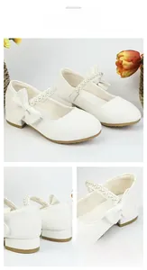 Detail view of white glitter Mary Jane shoes for girls featuring pearls and bow accents