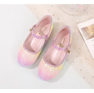 Macro shot of pink yellow gradient sequin Mary Janes with purple strap and pearl charm