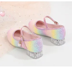 Close-up of glitter rainbow princess shoes with pearl charm and transparent diamond heel