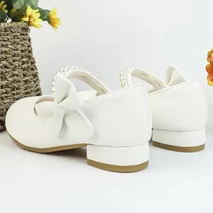 Elegant white Mary Jane princess shoes for girls with pearl strap and bow detail