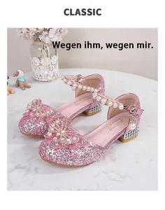 Detail of pink glitter Mary Jane shoes with pearl strap and rhinestone encrusted heels