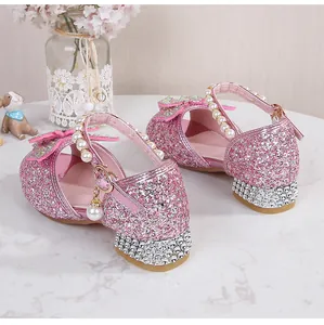 Detail of pink glitter girls princess heels with rhinestones and pearl strap