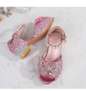 Detailed macro of pink sequin girl sandals with rhinestone bow and pearl strap