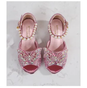 Detailed view of pink sequin girl's princess sandals with rhinestone bow and pearl strap