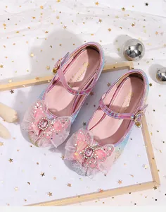 Macro view of pink glitter Mary Jane shoe with sequined bow and heart-shaped buckle detail