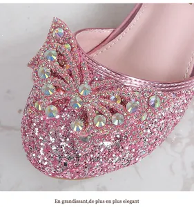 Close-up of pink glitter girls' princess shoes with sparkling rhinestone bow detail