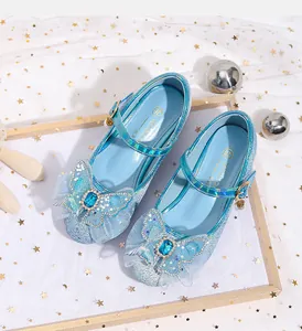 Detail of blue sequin Mary Jane shoes with lace bow and heart gemstone for girls