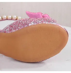 Detail view of pink glitter sandals with non-slip flower pattern rubber sole and pearls