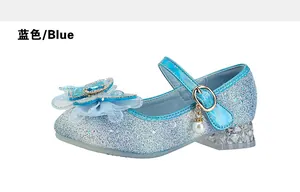 Detail of blue sequin Mary Jane shoes for girls featuring rhinestone bows and crystal heels