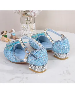 Detailed view of light blue glitter princess shoes with rhinestone bow and pearl strap