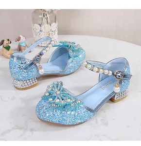 Detailed view of blue glitter princess shoes with rhinestone bow and pearl strap