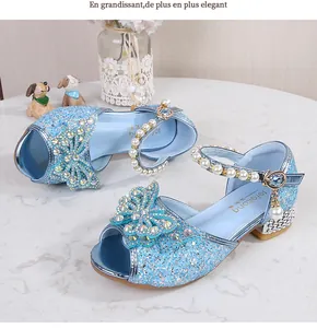 Close-up of girls' blue sequin princess sandals with rhinestone bow and pearl strap