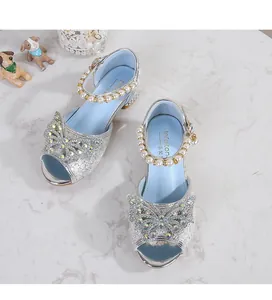 Detail of silver sparkling girls princess sandals with rhinestone bow and pearl straps