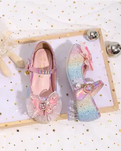 Close-up of rainbow glitter Mary Jane shoes with pink lace bow and pearl pendant