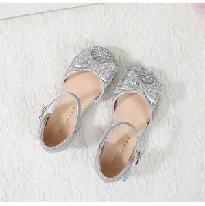 Close-up of silver glitter princess shoes with a bow detail and secure buckle strap