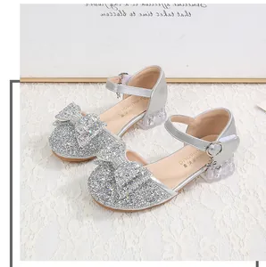 Macro shot of silver sequin princess shoes with crystal heels and floral detail