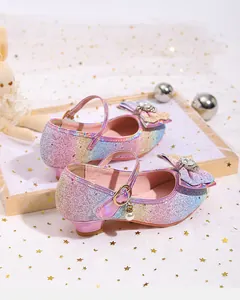 Detail of glitter girls princess shoes with rhinestone bow and pearl ball charm