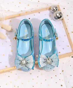 Detail of blue sequin princess shoes with crystal crown bow and pearl buckle