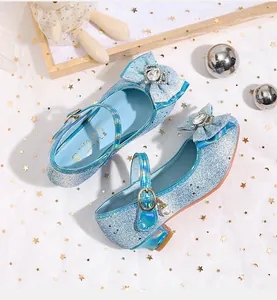 Detail of girls princess shoes with blue sequins, crystal crown bow and pearl charm