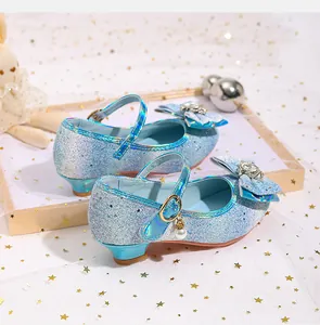 Detailed view of light blue sparkly girls princess shoes with bow and pearl pendant