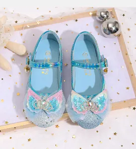 Detailed view of blue sequin Mary Jane shoe with rhinestone crown and pearl charm