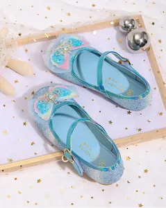 Detailed view of kids' blue sequin princess shoes with crystal crown and bow decoration
